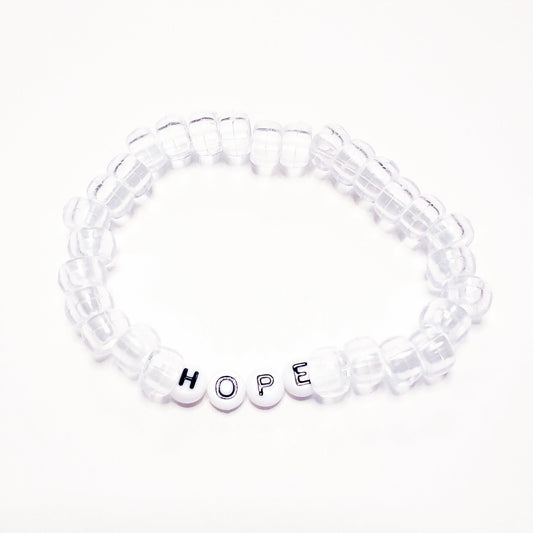 Clear beaded bracelet with round white letter beads spelling HOPE in black letters