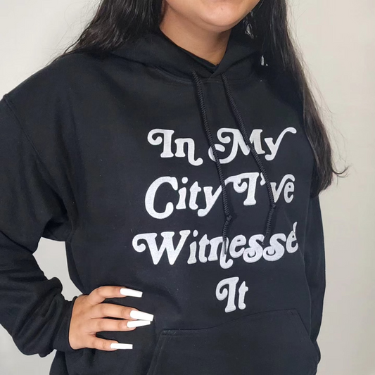 Black I've Witnessed It hoodie with white text worn by a teen against a plain white background